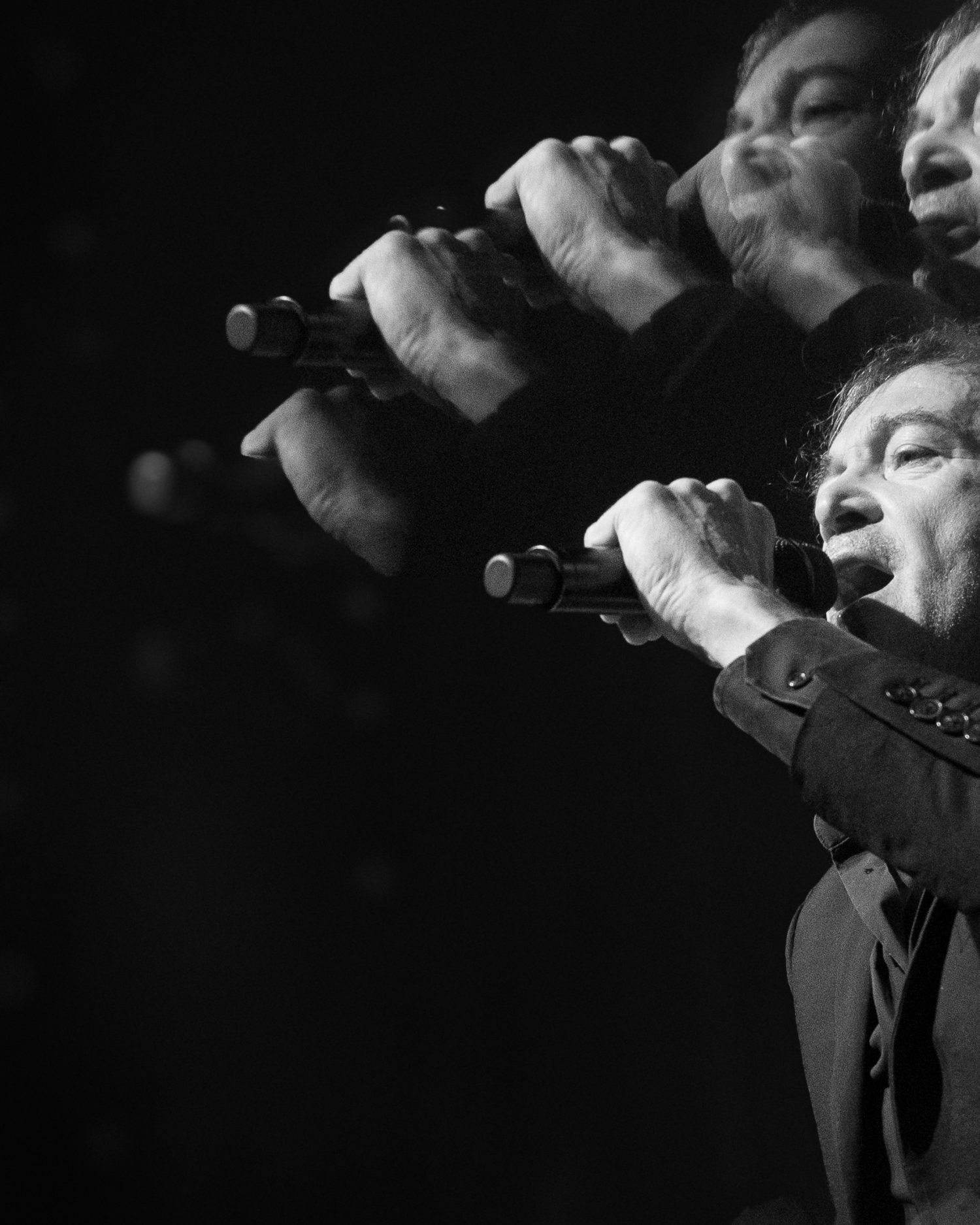 Cali Live performance in Paris by Minuit Studios Texas Cali French singer live performance photography during a Parisian concert starring right at the photographer - Minuit studios music concert imagery - black and white with a prismatic effect